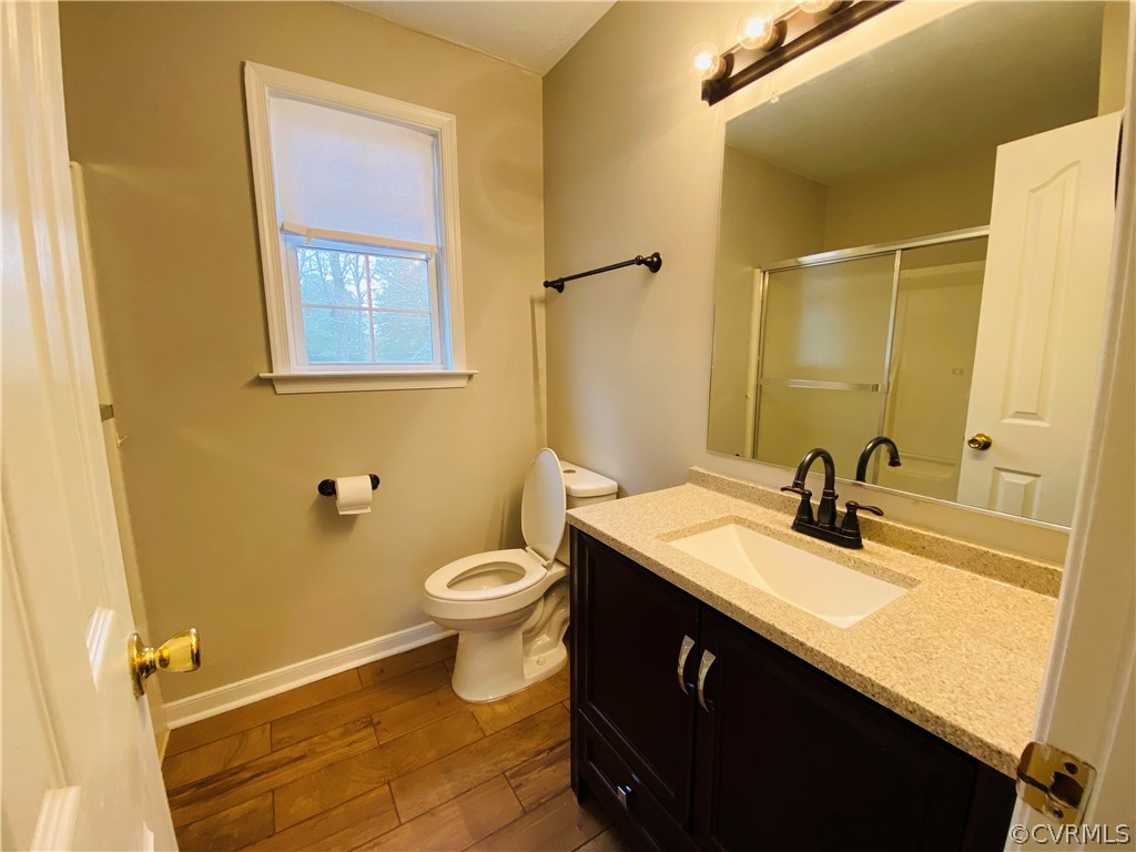 6956 Fox Drive Prince George, VA 23875 - Photo 13 of 26 a bathroom with a sink a toilet and mirror