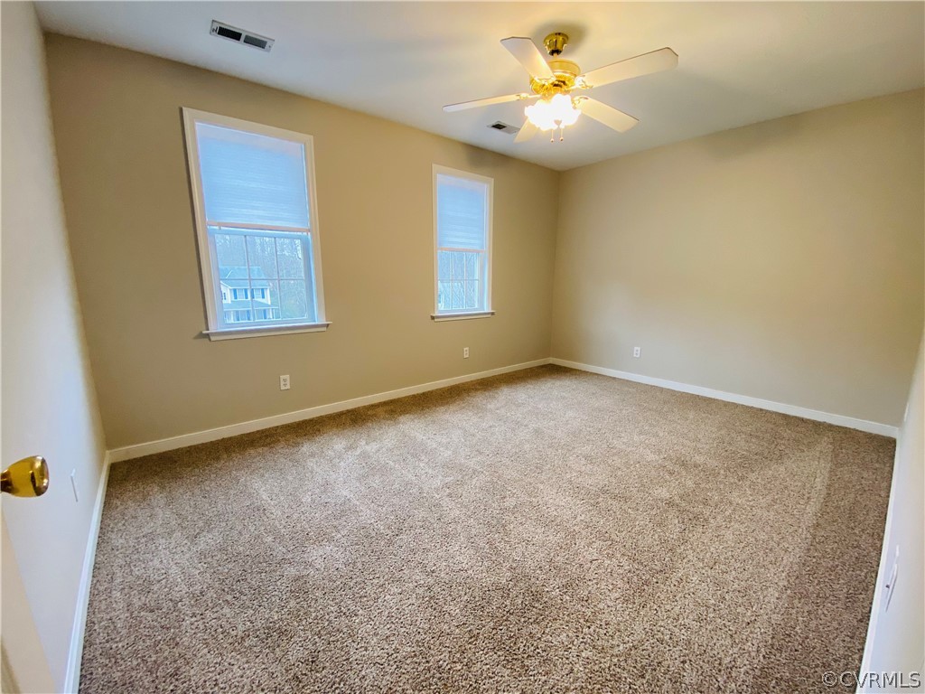 6956 Fox Drive Prince George, VA 23875 - Photo 15 of 26 an empty room with windows and fan