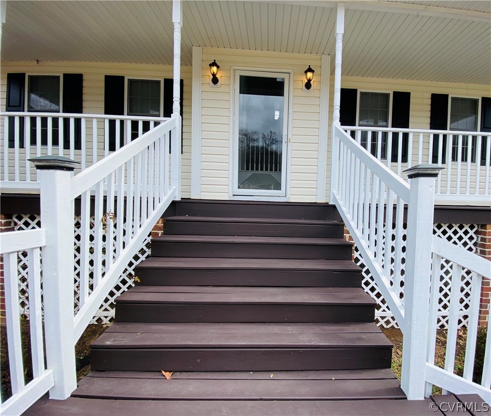 6956 Fox Drive Prince George, VA 23875 - Photo 2 of 26 a view of staircase with lots of frames on wall and a window