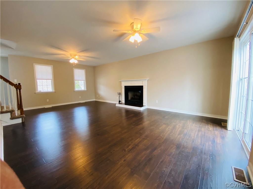 6956 Fox Drive Prince George, VA 23875 - Photo 4 of 26 a view of an empty room with window and wooden floor
