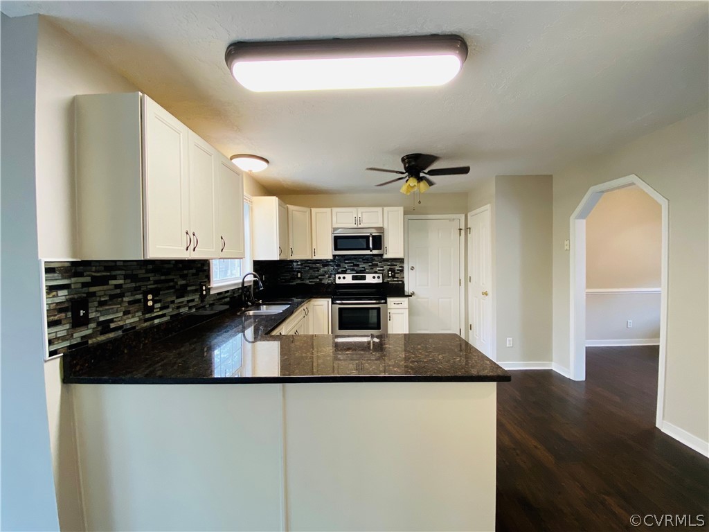6956 Fox Drive Prince George, VA 23875 - Photo 7 of 26 a kitchen with granite countertop stainless steel appliances and wooden cabinets
