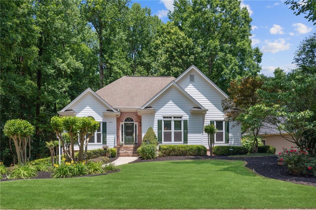 4930 Ansley Lane Cumming, GA 30040 - Photo 1 of 1 a front view of a house with a yard