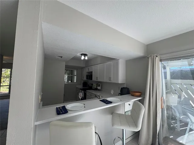 a kitchen with a table chairs and a refrigerator