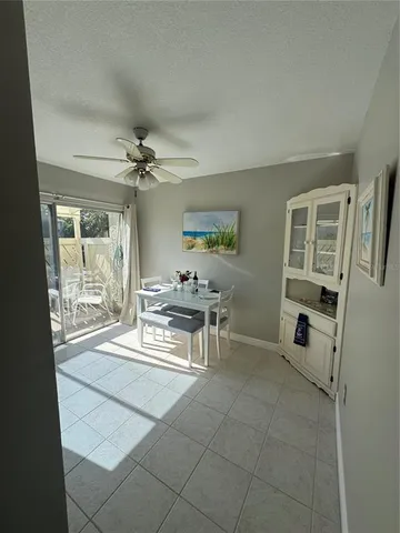 a dining room with furniture and a floor to ceiling window