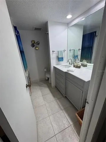 a room with a sink vanity and mirror