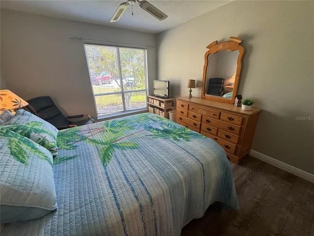 a bedroom with a bed and a large window