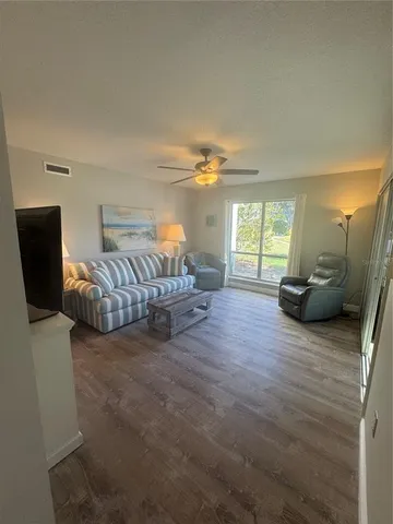 a view of livingroom with furniture wooden floor and window