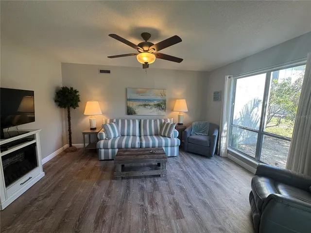 a kitchen with a white table chairs and a refrigerator