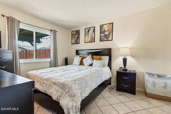 a bedroom with a bed and a night stand