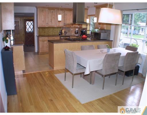 34 Glen Gary Road Middlesex, NJ 08846 - Photo 2 of 14 a kitchen with kitchen island granite countertop a stove a sink a dining table and chairs