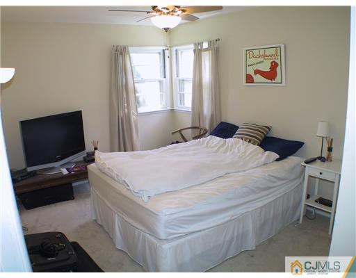 34 Glen Gary Road Middlesex, NJ 08846 - Photo 8 of 14 a bedroom with a bed and a flat screen tv