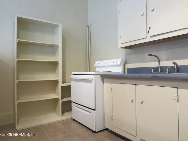 a white toilet sitting next to a bathroom sink