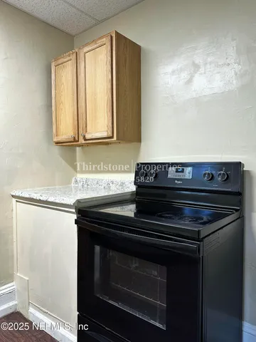 a stove top oven sitting inside of a kitchen