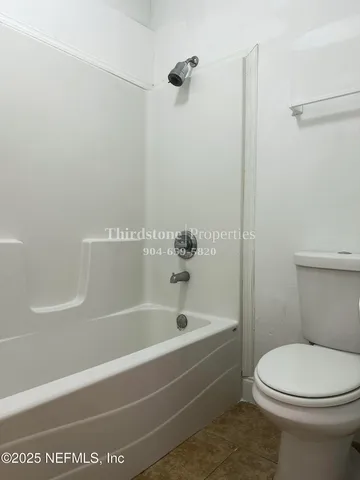 a bathroom with a bathtub and a toilet