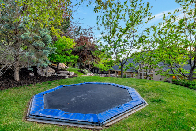 577 South Ridge Top Lane East North Salt Lake, UT 84054 - Photo 49 of 57 Expansive backyard offering mature trees, open green space, and endless possibilities for recreation, relaxation, or play.
