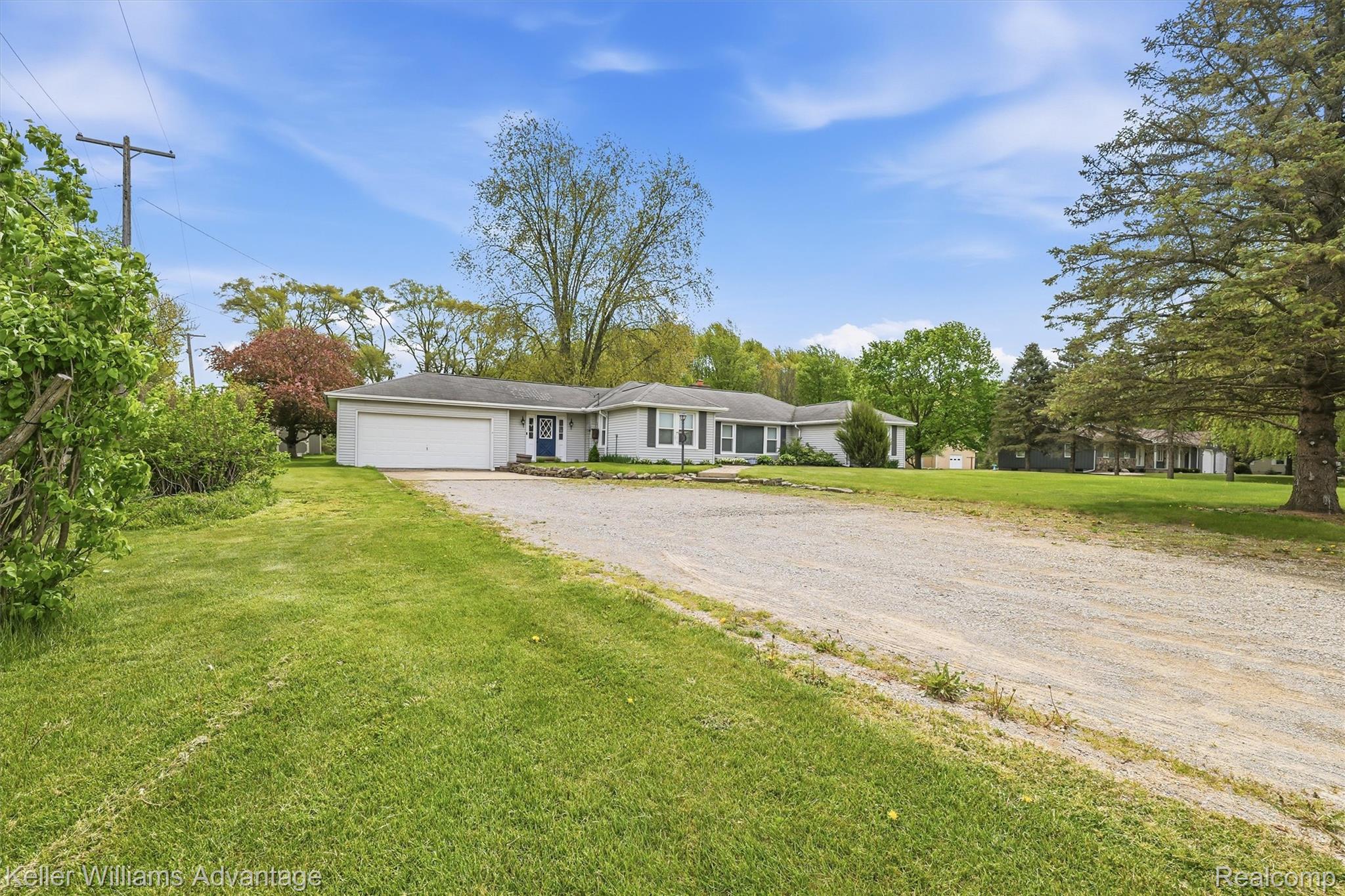 6595 Bray Road Vassar, MI 48768 - Photo 3 of 64 Ranch-style home featuring a front yard, driveway, and a garage