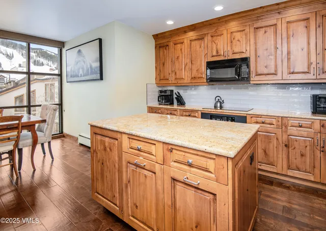 a view of a hallway and a livingroom with furniture