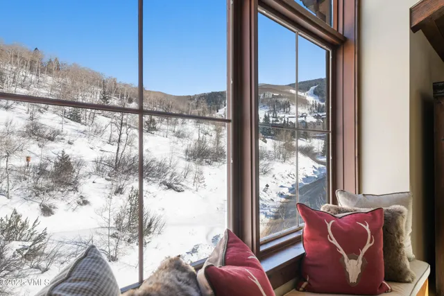 a bedroom with a bed and a flat tv screen on wall