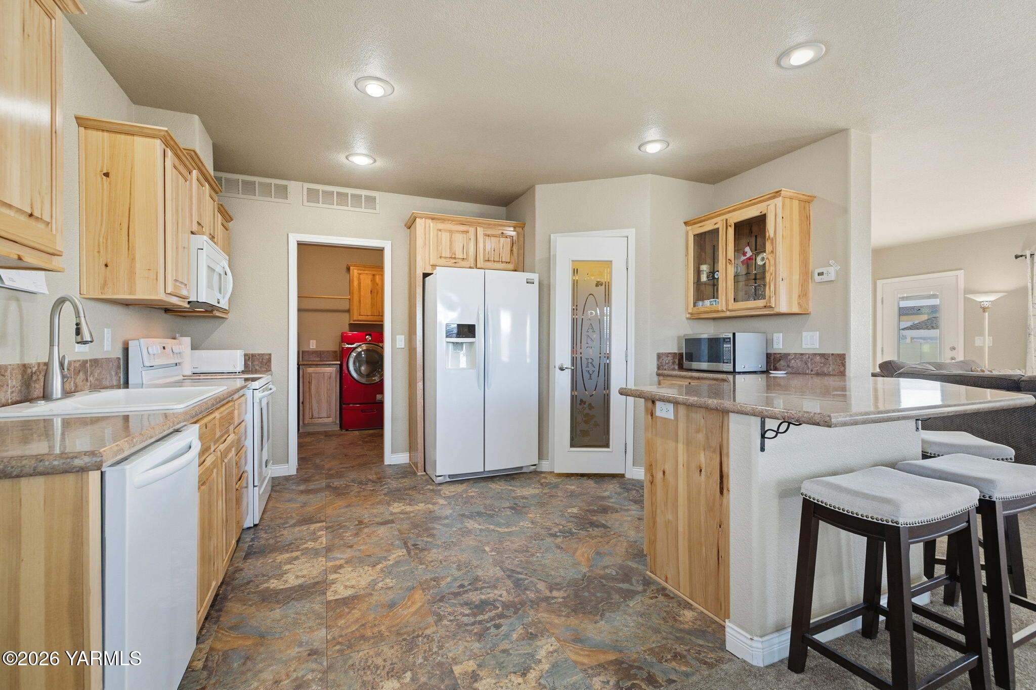 200 Bridle Way, Unit 165 Yakima, WA 98901 - Photo 5 of 21 a kitchen with refrigerator cabinets and chairs