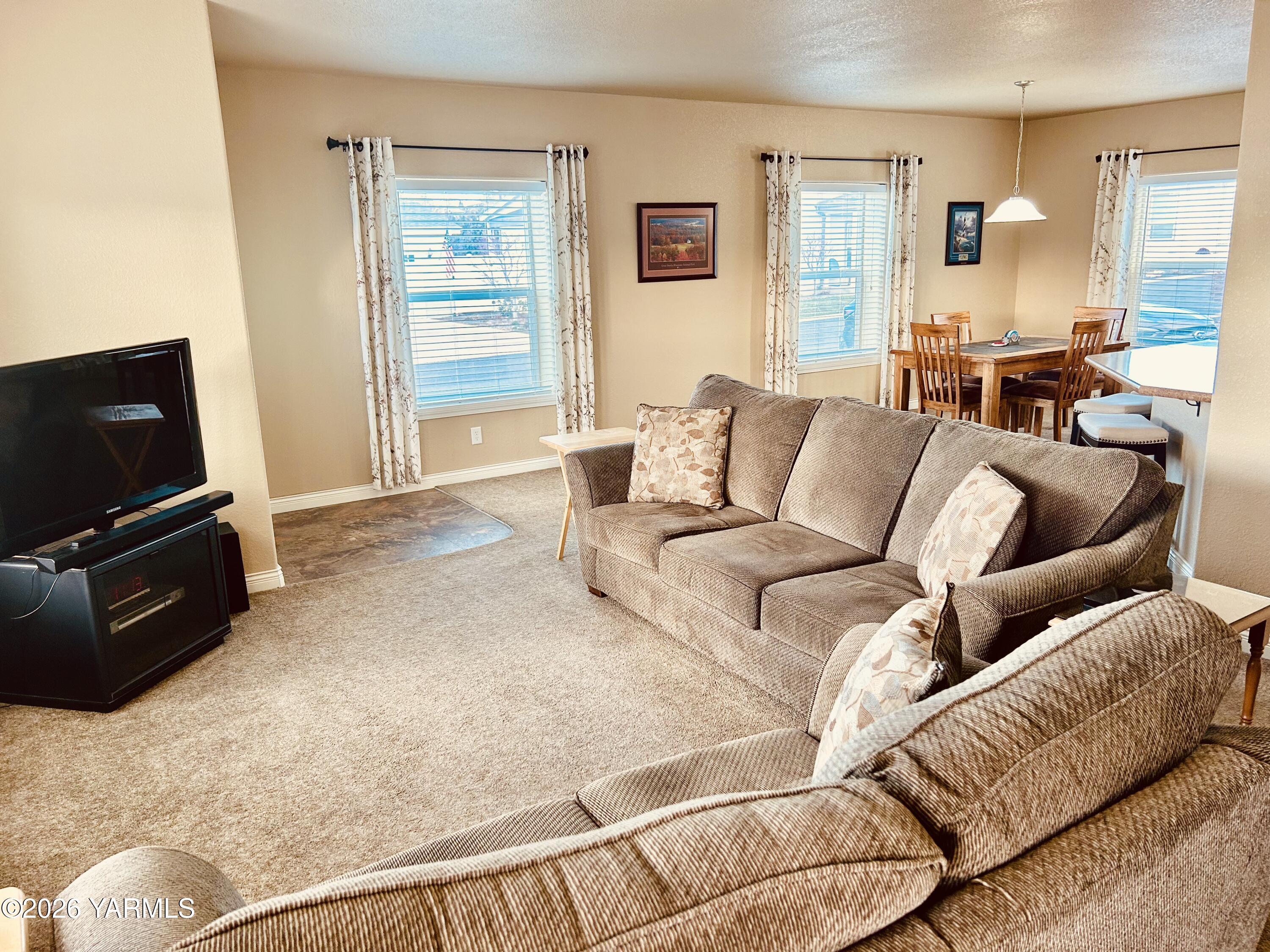 200 Bridle Way, Unit 165 Yakima, WA 98901 - Photo 6 of 21 a living room with furniture a flat screen tv and a window