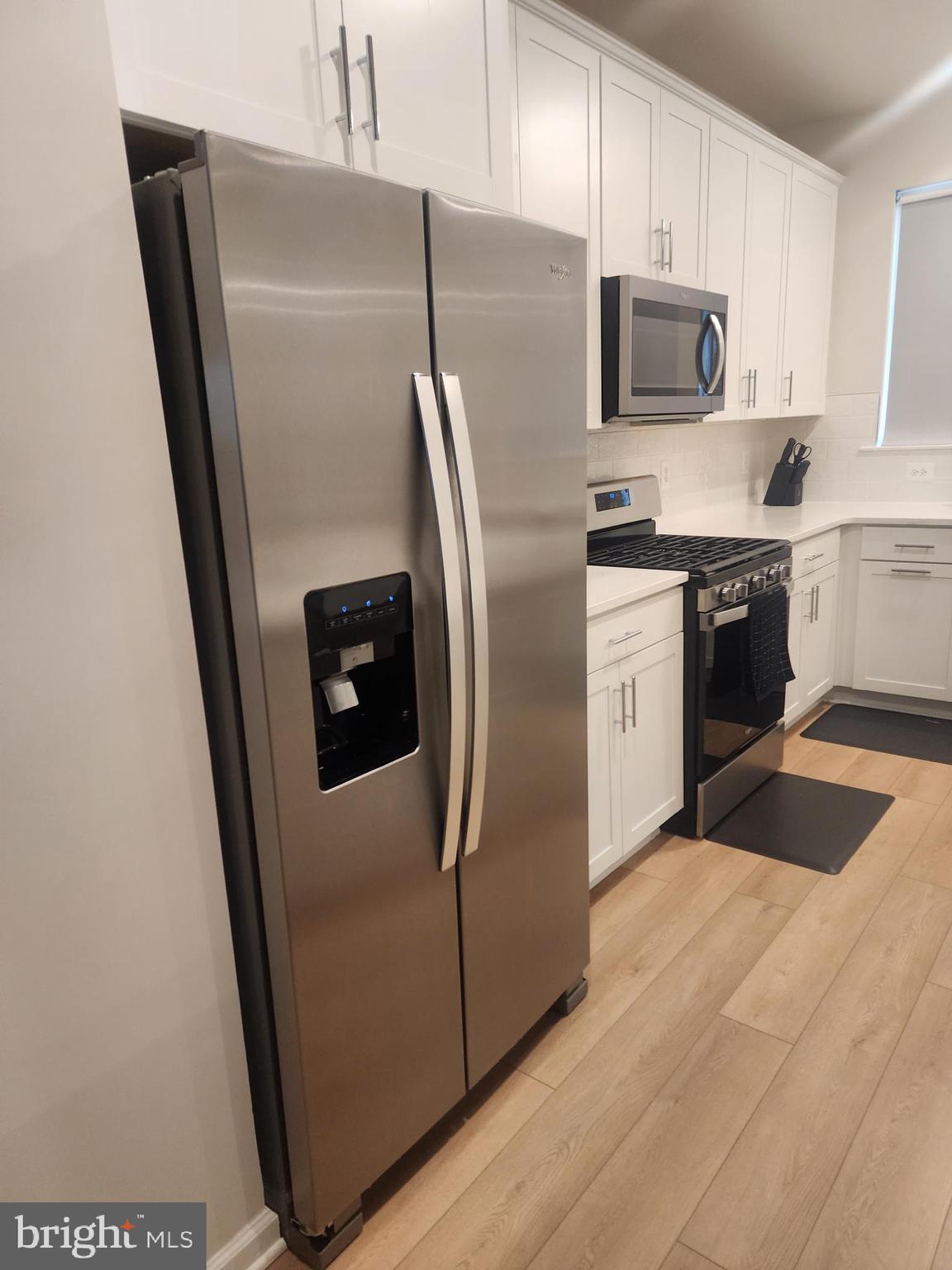 234 Mainstream Drive Laurel, MD 20724 - Photo 19 of 40 a kitchen with stainless steel appliances a refrigerator sink and microwave