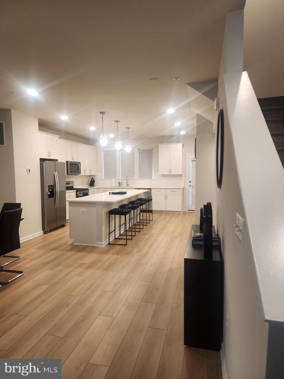 234 Mainstream Drive Laurel, MD 20724 - Photo 25 of 40 a living room with stainless steel appliances kitchen island granite countertop a sink a refrigerator and a stove