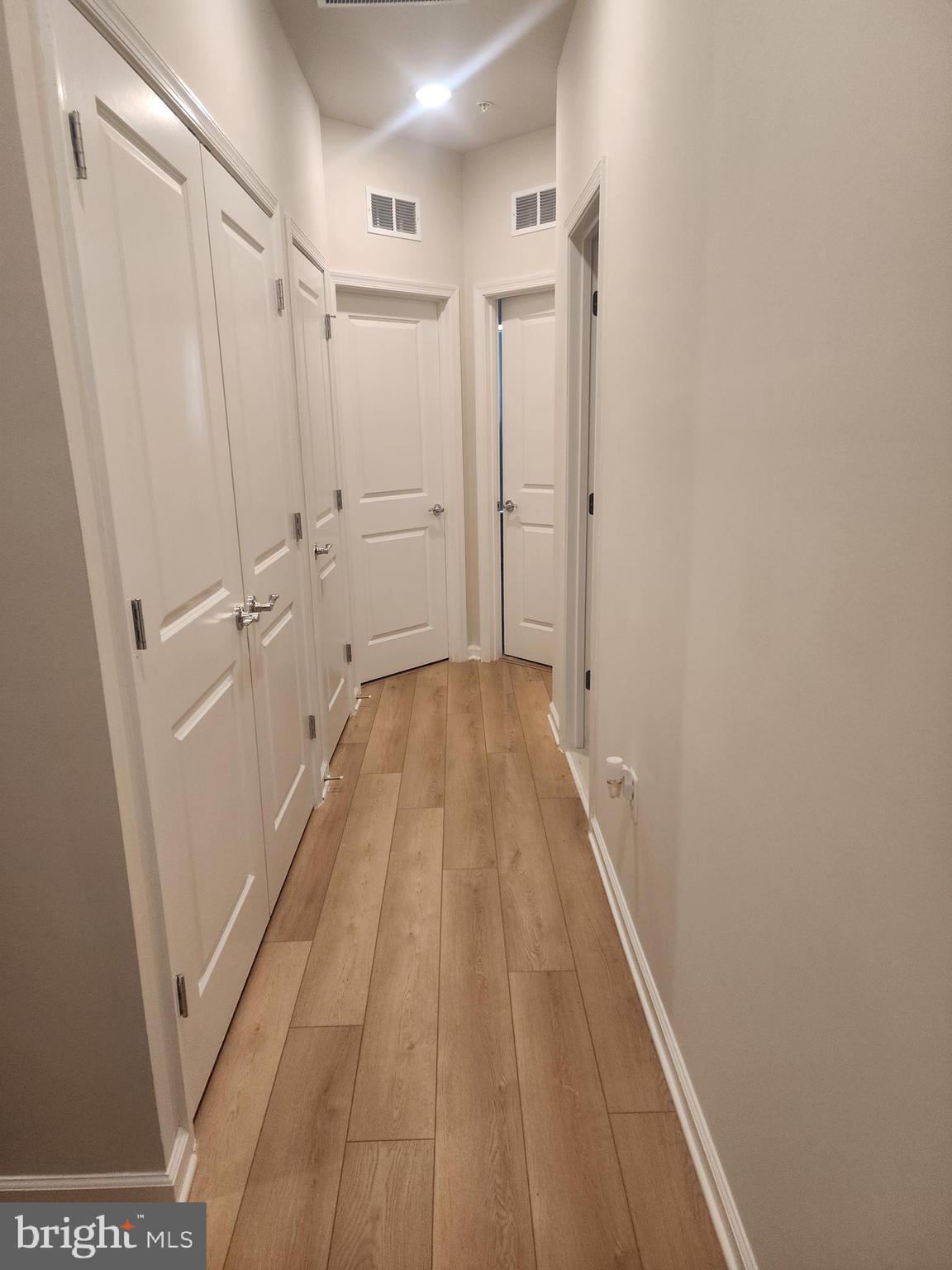 234 Mainstream Drive Laurel, MD 20724 - Photo 31 of 40 a view of a hallway with wooden floor and staircase