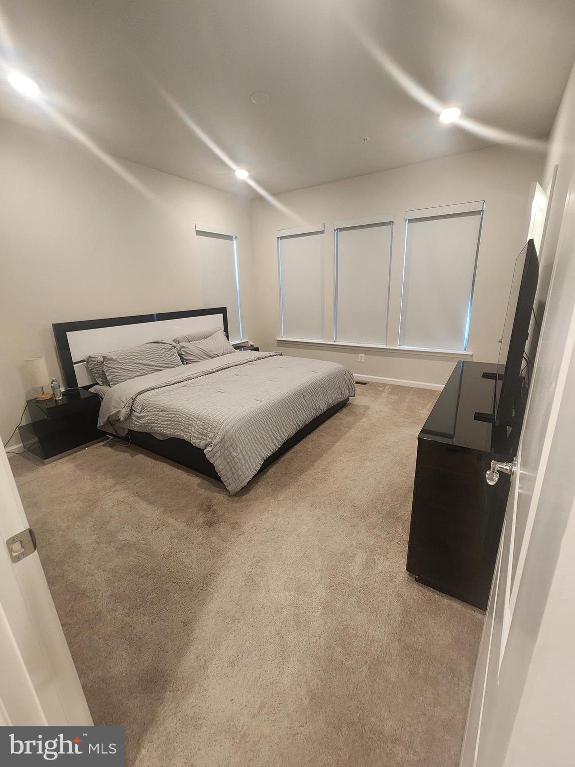 234 Mainstream Drive Laurel, MD 20724 - Photo 32 of 40 a spacious bedroom with a bed and a couch