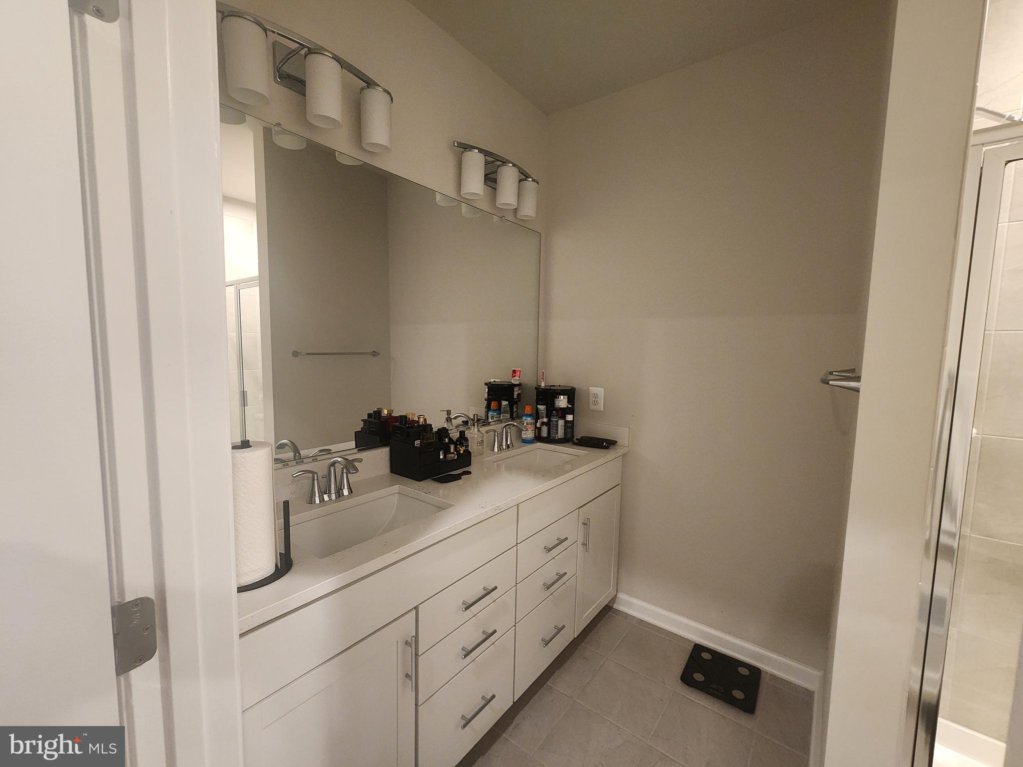 234 Mainstream Drive Laurel, MD 20724 - Photo 33 of 40 a bathroom with a double vanity sink and mirror