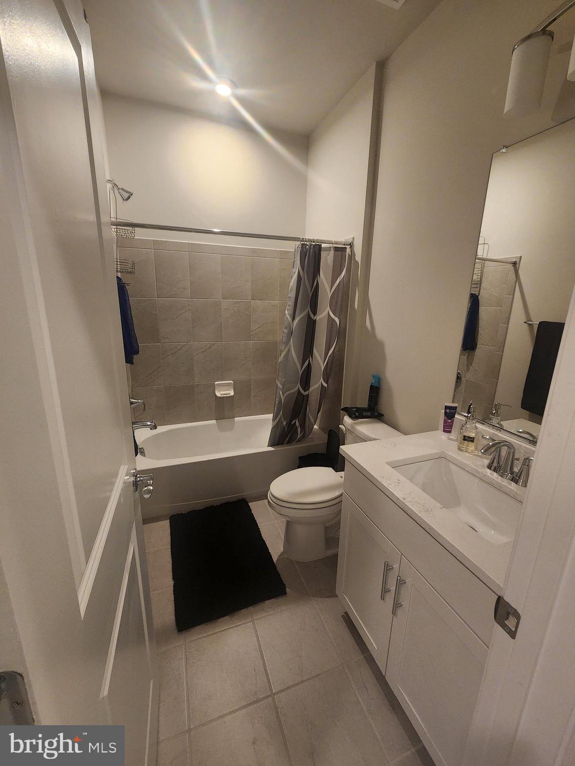 234 Mainstream Drive Laurel, MD 20724 - Photo 38 of 40 a bathroom with a toilet sink and mirror