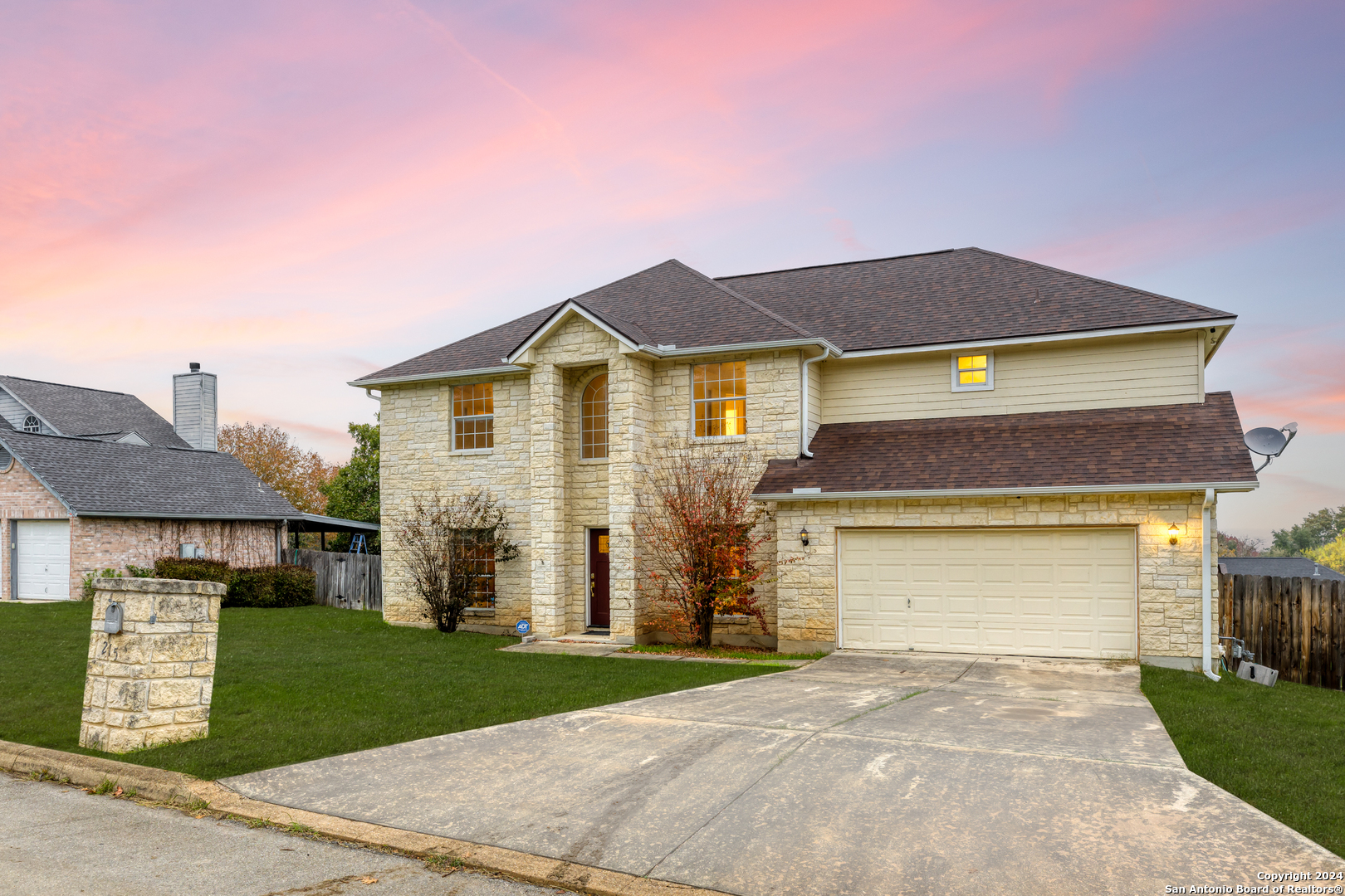 a front view of a house with a yard and garage