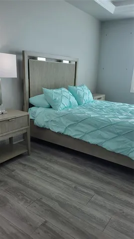 a bedroom with a bed and a night stand