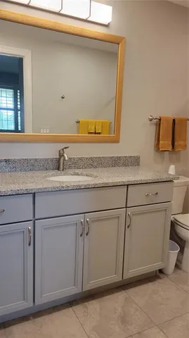 a sink with white cabinets