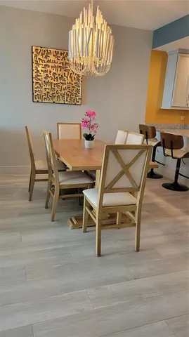 a view of a dining room with furniture and a chandelier