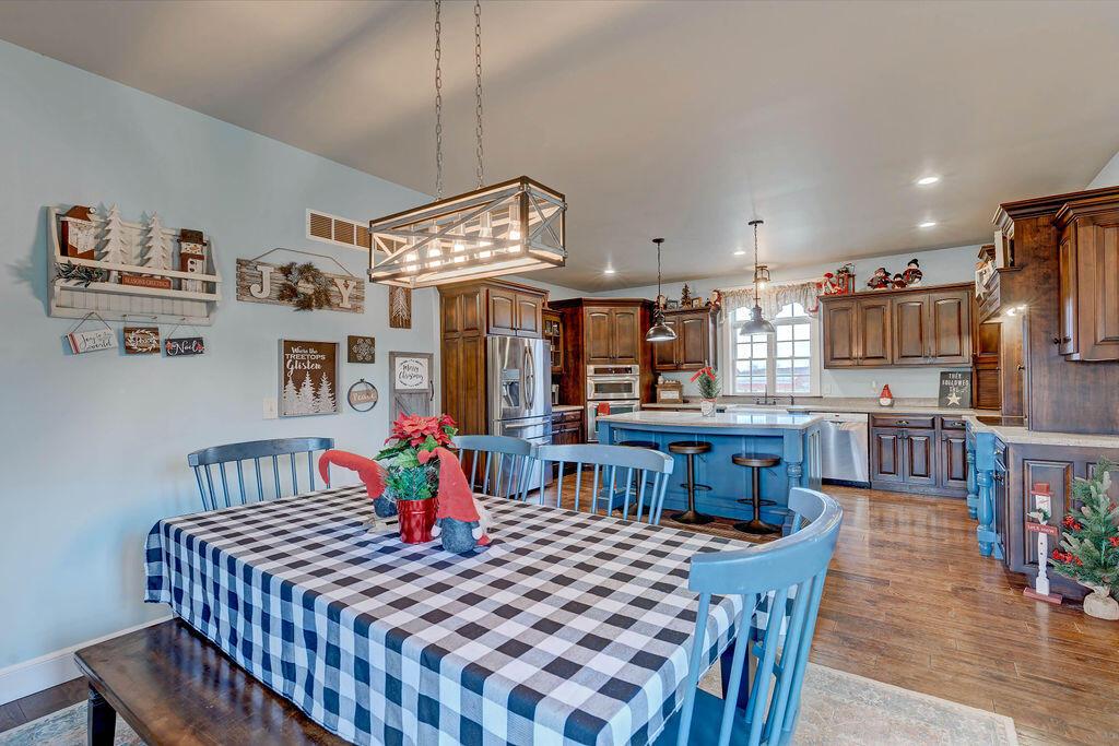 4045 Russell Road Mount Gilead, OH 43338 - Photo 18 of 74 • Handscraped hardwood flooring • Baby blue painted walls • Lighting above table • Bench seating around window