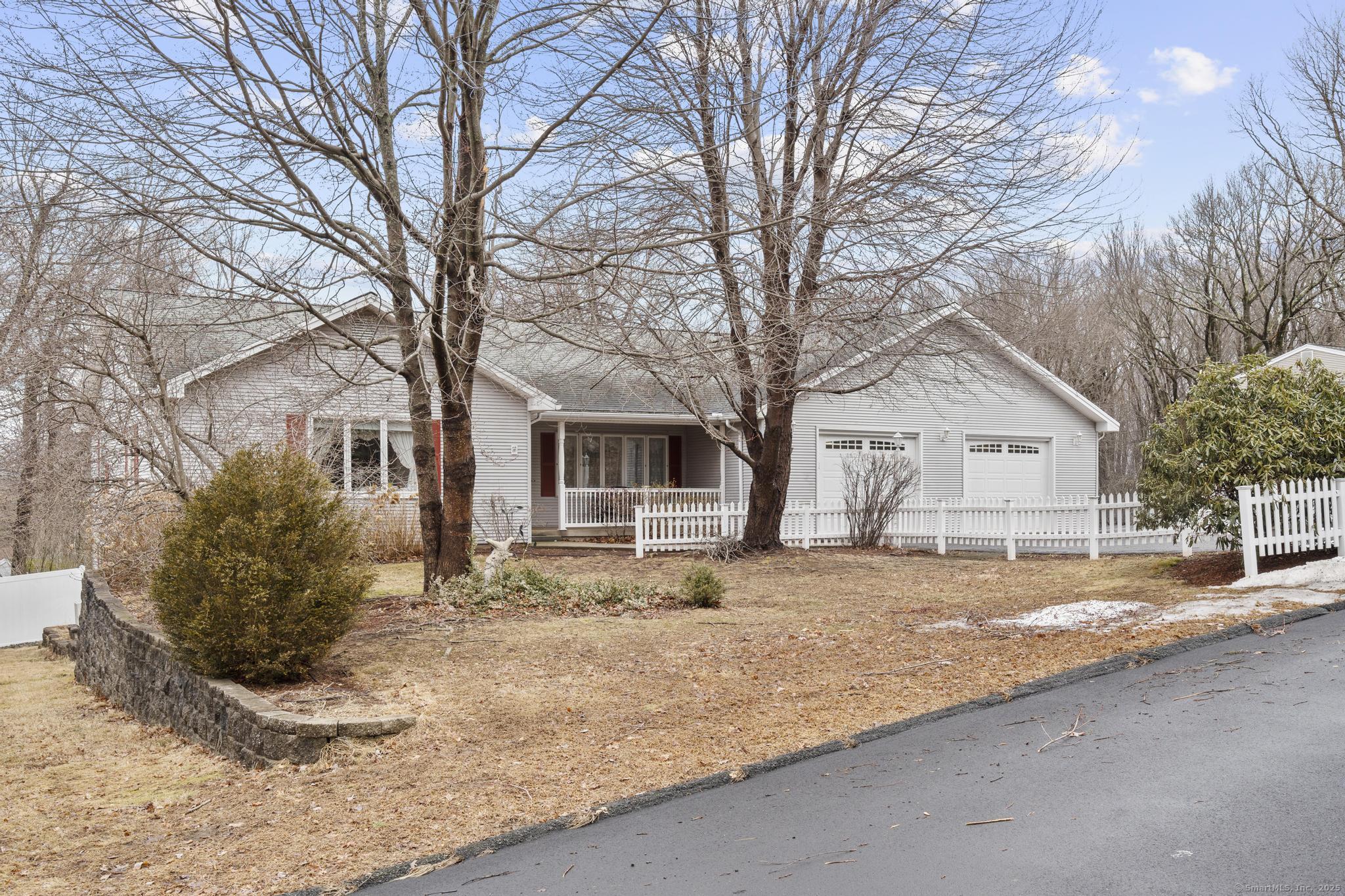 a view of a house with a yard covered in snow