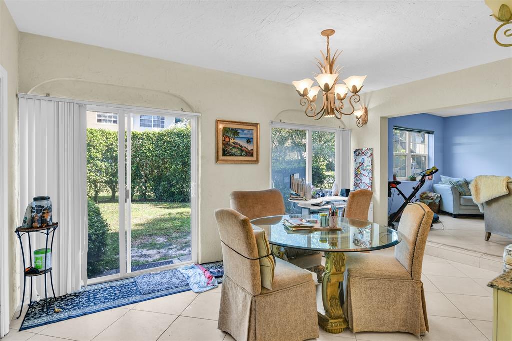 6693 Via Regina, Unit 6693 Boca Raton, FL 33433 - Photo 15 of 27 a view of a dining room with furniture window and outside view