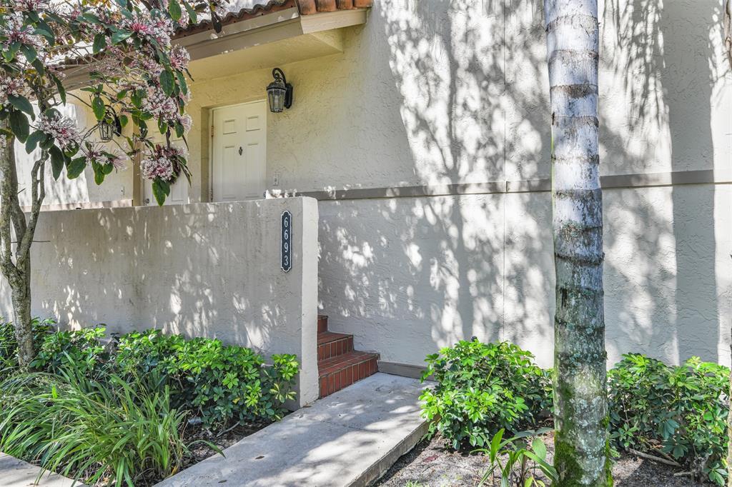 6693 Via Regina, Unit 6693 Boca Raton, FL 33433 - Photo 2 of 27 a backyard of a house with lots of green space