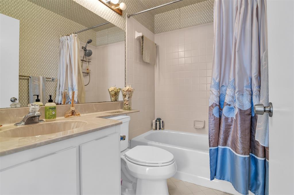 6693 Via Regina, Unit 6693 Boca Raton, FL 33433 - Photo 21 of 27 a bathroom with a granite countertop sink toilet and shower