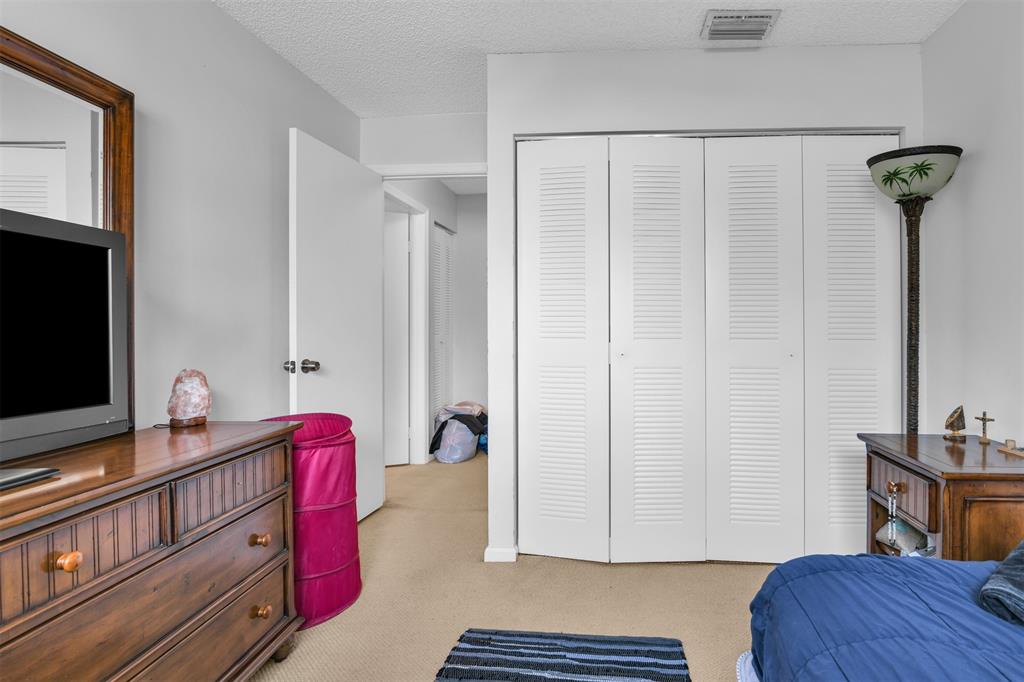 6693 Via Regina, Unit 6693 Boca Raton, FL 33433 - Photo 25 of 27 a view of bedroom with furniture and wooden floor