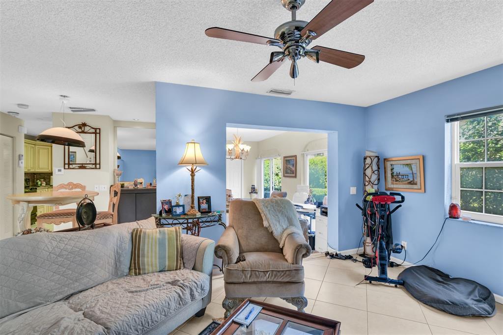6693 Via Regina, Unit 6693 Boca Raton, FL 33433 - Photo 10 of 27 a living room with furniture gym equipment and a flat screen tv