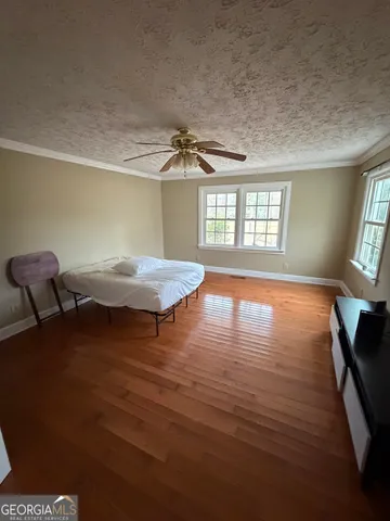 a room with wooden floor and windows