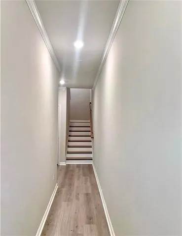 a view of a hallway with wooden floor