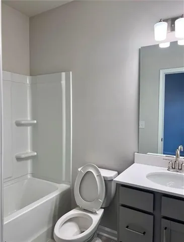 a bathroom with a toilet a sink and bathtub