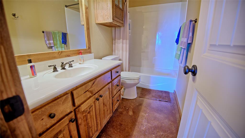 4509 Lazy E Road St. Jo, TX 76265 - Photo 21 of 39 a bathroom with a sink and a mirror