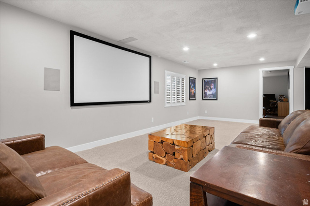 3359 Eurasian Crane Road Clinton, UT 84015 - Photo 43 of 71 Cinema room with light colored carpet, a textured ceiling, and recessed lighting