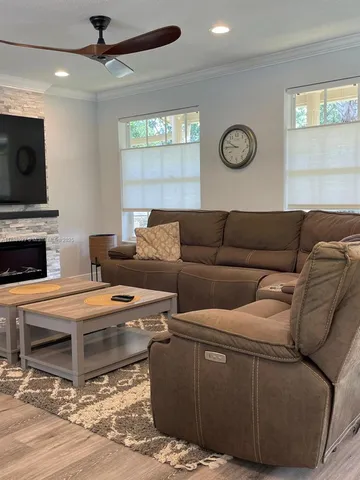 a living room with furniture a fireplace and a window