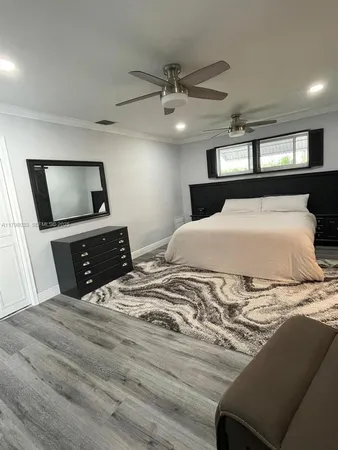 a large bedroom with a bed and a couch
