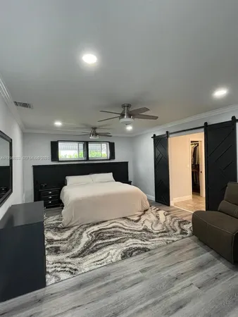 a spacious bedroom with two beds and a chandelier