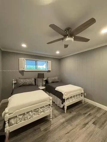 a spacious bedroom with two beds and a chandelier